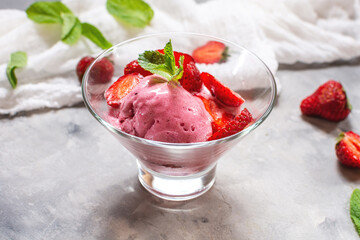 Homemade strawberry ice cream decorated with fresh berries and mint