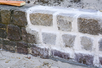 Cleaning of cobble square stone walls and restoration of seams