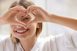 Healthy Eyes And Vision. Woman Holding Heart Shaped Hands Near Eyes. Girl Smiling and Showing Heart Symbol with Hands. Vision Correction Concept