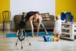 © irissca - Young mother fitness instructor personal trainer record video near camera at home with baby daughter