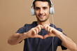 © SHOTPRIME STUDIO - handsome man wearing white headphones posing music entertainment cropped view