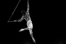 Muscular Male Air Circus Artist Performances With Dance Trapeze 