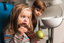 Reward For Bad Teeth, Little Girl Eating A Chocolate, Dental Office