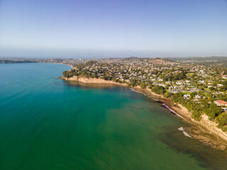 Wall Mural - Spectacular beachfront properties seen aerially from the sky by drone in Red beach, New Zealand 