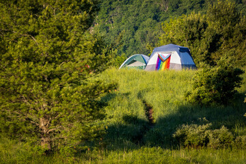 Camping outdoors with pride LGBT flag on tent and nobody