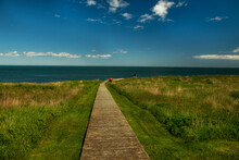 Wooden Path To The Island Overlooking The Ocean. Atlantic Ocean. USA. Canada. Maine.
