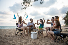 Group Of Asian Young Man And Woman Having Party On The Beach Together. 
