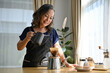 © bongkarn - Happy asian aged woman brewing coffee in the morning at home