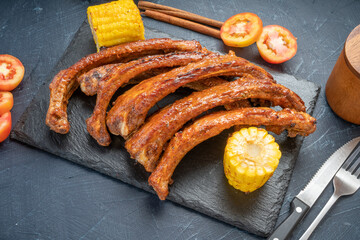 Wall Mural - Honey BBQ Pork Ribs, Pork Spare Ribs with Barbecue spicy sauce, Grilled sliced barbecue pork ribs on black plate.