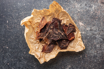 Canvas Print - Beef jerky meat. Dried sliced meat on paper.