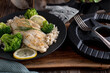 Fitness meal with seared fish fillet, brown rice and broccoli on a plate