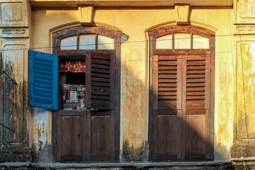 Sticker - Beautiful ruined vintage wooden windows of an old Chinese shop house in the heritage town of Georgetown in Penang, Malaysia.