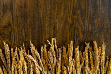 Wooden background along the edge with cereals. Decorations for background.