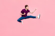 Full size profile side photo of young man jump rejoice luck fists hands isolated over pink color background