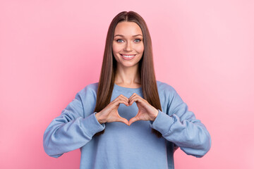 Sticker - Portrait of attractive girly cheerful girl showing heart symbol amour isolated over pink pastel color background