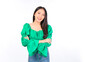 © Png - Video - Photo - Attractive beautiful positive happy smile asian woman hands point up and pose with empty space wearing green shirt and jeans.