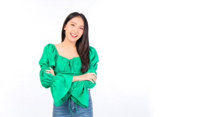 Attractive beautiful positive happy smile asian woman hands point up and pose with empty space wearing green shirt and jeans.