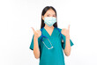 © Png - Video - Photo - Portrait of professional confident young asian female smiling doctor in green scrubs protection flu cold facial mask showing presenting finger to stop talking sign gesture silence and secret concept.