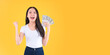 © Png - Video - Photo - US dollars money in hand, happy pretty asian female showing a lot money in her hands winner successful in business bankruptcy economic financial concept.