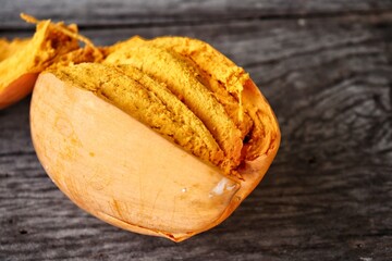 Poster - Canistel fruit on wood background