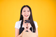 © Png - Video - Photo - asian female smile wearing black apron holding paper bag and payment with a credit card through terminal money swiping a credit card