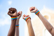 © luisrojasstock - Four fists claiming gay pride rights with gay pride bracelet