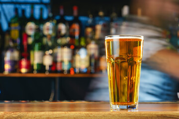 Wall Mural - Fresh cold beer in glass on bar background