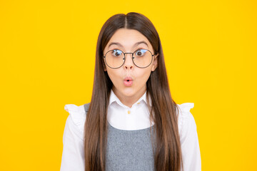 Studio shot of emotional adorable little girl surprised and shocked, showing true astonished reaction on unexpected news. Funny teenager child girl face.