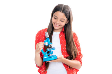 Wall Mural - Teenager school girl with microscope. Back to school. Girl scientist isolated on white. Portrait of happy smiling teenage child girl.