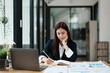 © Jirapong - A portrait of an economist or an accountant or a financier and an investor examining budget documents and using computers to study the impact and risk assessment of corporate investment management