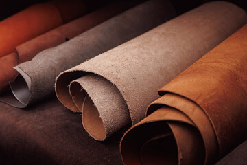 Different rolls natural leather brown and beige color dark background