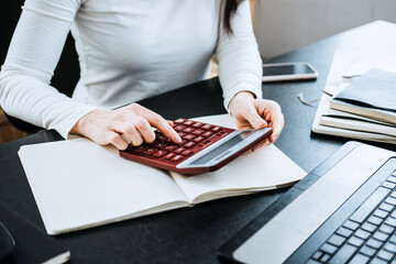 Wall Mural - Accounting Formulas Equations for Accountants. Female Accountant working with calculator and laptop