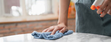 Asian Woman Cleaning The Table Surface With Towel And Spray Detergent