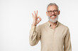 © InsideCreativeHouse - Positive happy caucasian mature middle-aged man smiling with toothy smile wearing glasses showing okay gesture isolated in white background