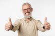 © InsideCreativeHouse - Happy european mature middle-aged man in beige shirt and glasses showing thumbs up with both hands, good quality, positive attitude isolated in white background