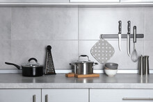 Set Of Cooking Utensils And Cookware On Grey Countertop