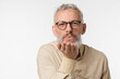 © InsideCreativeHouse - Romantic caucasian mature middle-aged man with grey hair wearing glasses sending air kisses to the camera isolated in white background. Love and relationship, passion concept