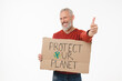 © InsideCreativeHouse - Smiling caucasian mature middle-aged male eco-activist holding poster with protect our nature logo showing thumb up isolated in white background. Environment ecology protection.