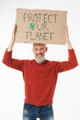 © InsideCreativeHouse - Caucasian mature man male eco-activist volunteer holding poster with protect our nature logo against air water plastic pollution, environment protection isolated in white background