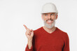 © InsideCreativeHouse - Closeup caucasian mature middle-aged man engineer architect construction worker builder in white hardhat pointing at copy space free space isolated in white background