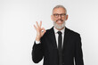 © InsideCreativeHouse - Smiling with toothy smile caucasian mature middle-aged businessman ceo boss lawyer teacher showing okay gesture in formal suit isolated in white background