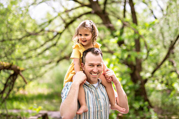 Wall Mural - Father with his daughter having fun outside in forest