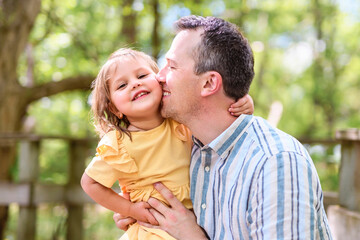 Wall Mural - Father with his daughter having fun outside in forest