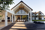 Fototapeta  - View of luxurious modern house exterior with dining space and garden