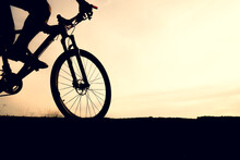 Silhouettes Of Mountain Bikes And Cyclists In The Evening Happily. Travel And Fitness Concept