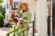 © mary_markevich - beautiful young woman in summer style outfit smiling happy walking with flowers in city street