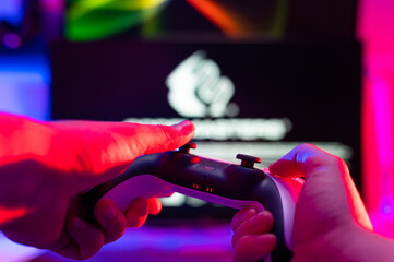 Sticker - Modern gamepad in the hands of a gamer. Video games, youth culture, new digital technologies, cyberspace, cybersport, recreation, relaxation, online communication, competitions.