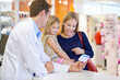 © Tabitha R/peopleimages.com - We have this one for kids.... A pharmacist giving medication to a mother and daughter.