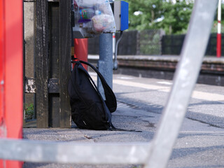 Suspicious rucksack left on railway platform wide shot