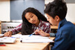 © Tasneem H/peopleimages.com - Solving their homework together. Shot of two young students studying together in a classroom.